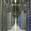 Blue lights glow in a server room inside a data center.