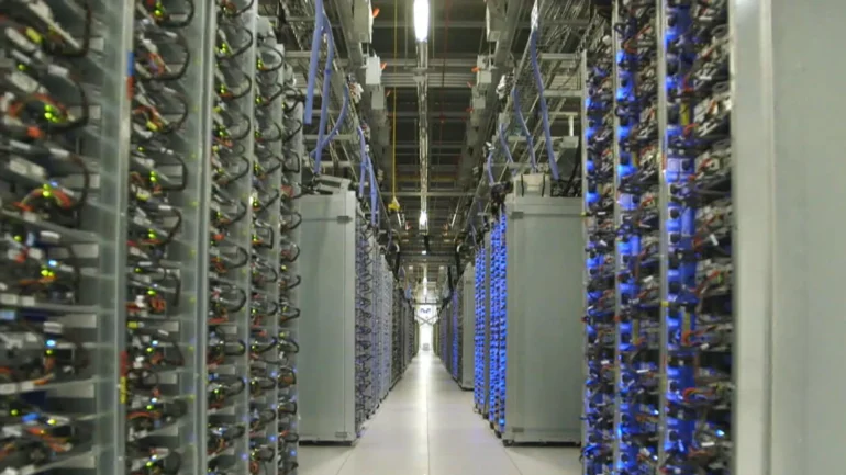 Blue lights glow in a server room inside a data center.