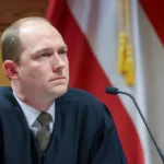 Judge Scott McAfee in a courtroom, looking intently.