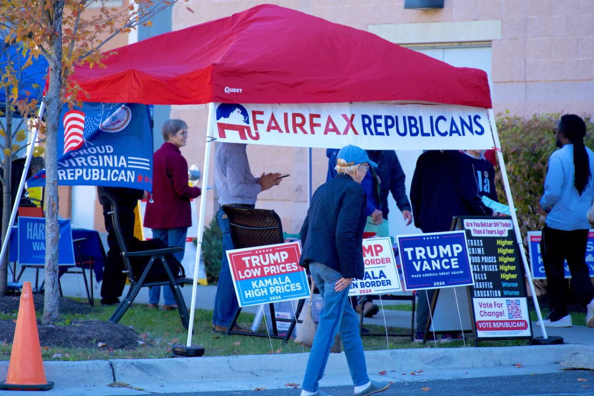Image of a red tent for Fairfax Republicans with Trump campaign signs