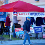 Image of a red tent for Fairfax Republicans with Trump campaign signs