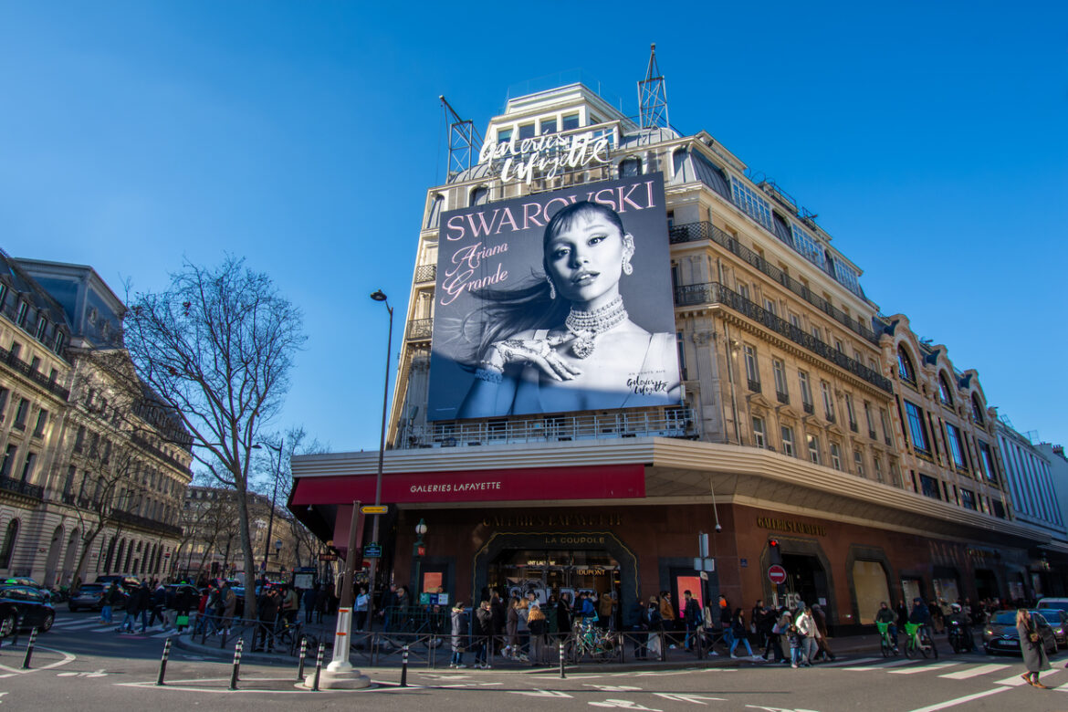 Advertising billboard for Swarovski starring singer-actress Ariana Grande, on the facade of Galeries Lafayette, Paris, France
