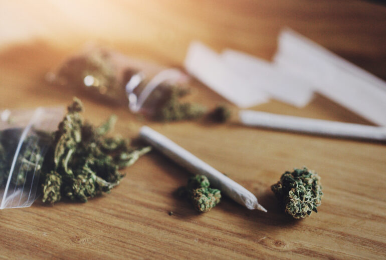Close up image of marijuana, buds and blunt on a table