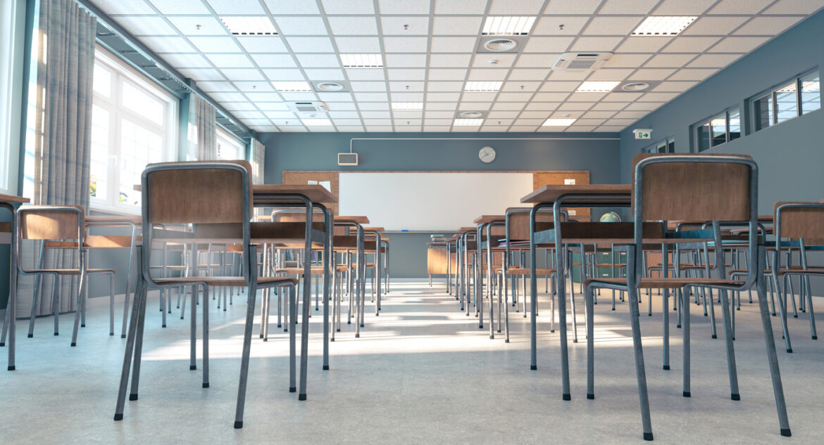 Classroom bathed in sunlight, with rows of empty desks and chairs, awaiting the beginning of a new school day