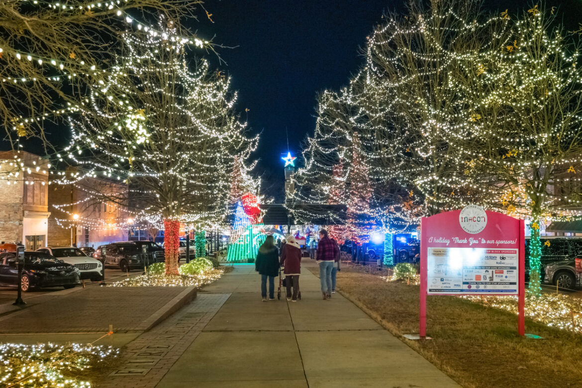 People visit the Christmas Light installation in downtown Macon, Georgia, on a winter evening.