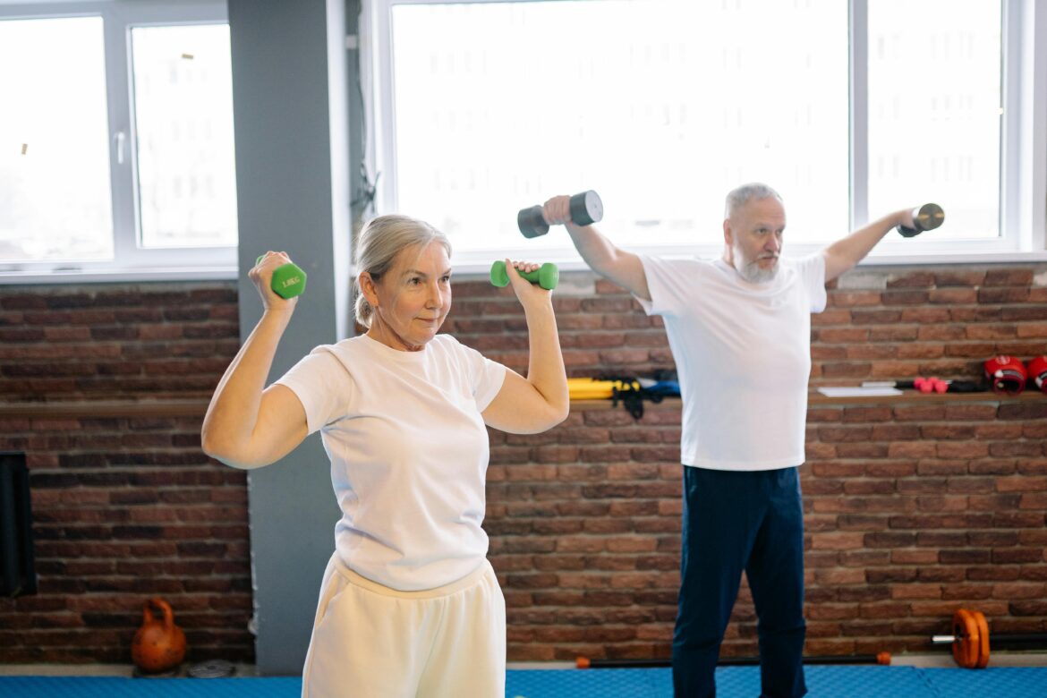 Two gray-haired people exercising.