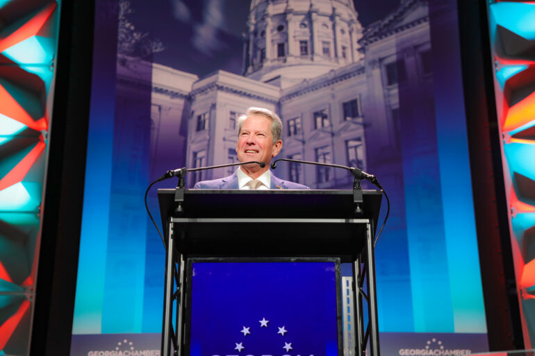 A photo of Gov. Brian Kemp speaking and smiling at the 2025 Georgia Chamber of Commerce’s Eggs and Issues legislative event.