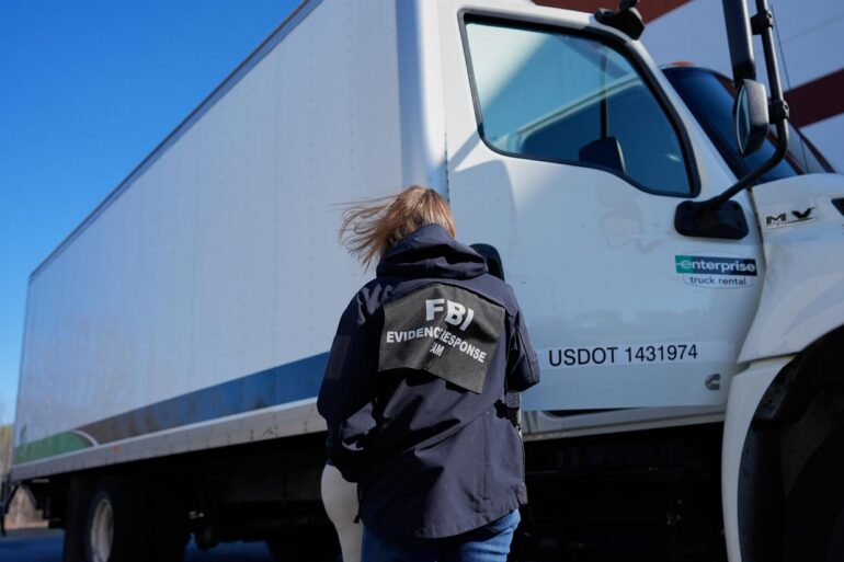 A FBI agent open the door of a U.S. Department of Transportation truck.