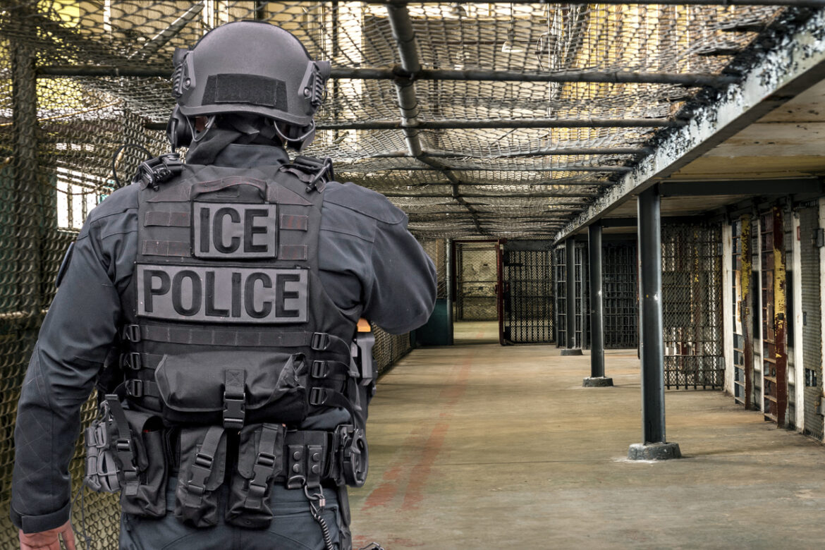 ICE Police walking in what looks like a detention facility