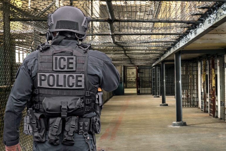 ICE Police walking in what looks like a detention facility