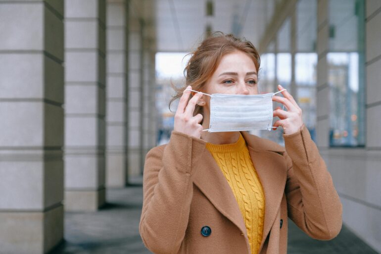 A woman masking up during flu season.