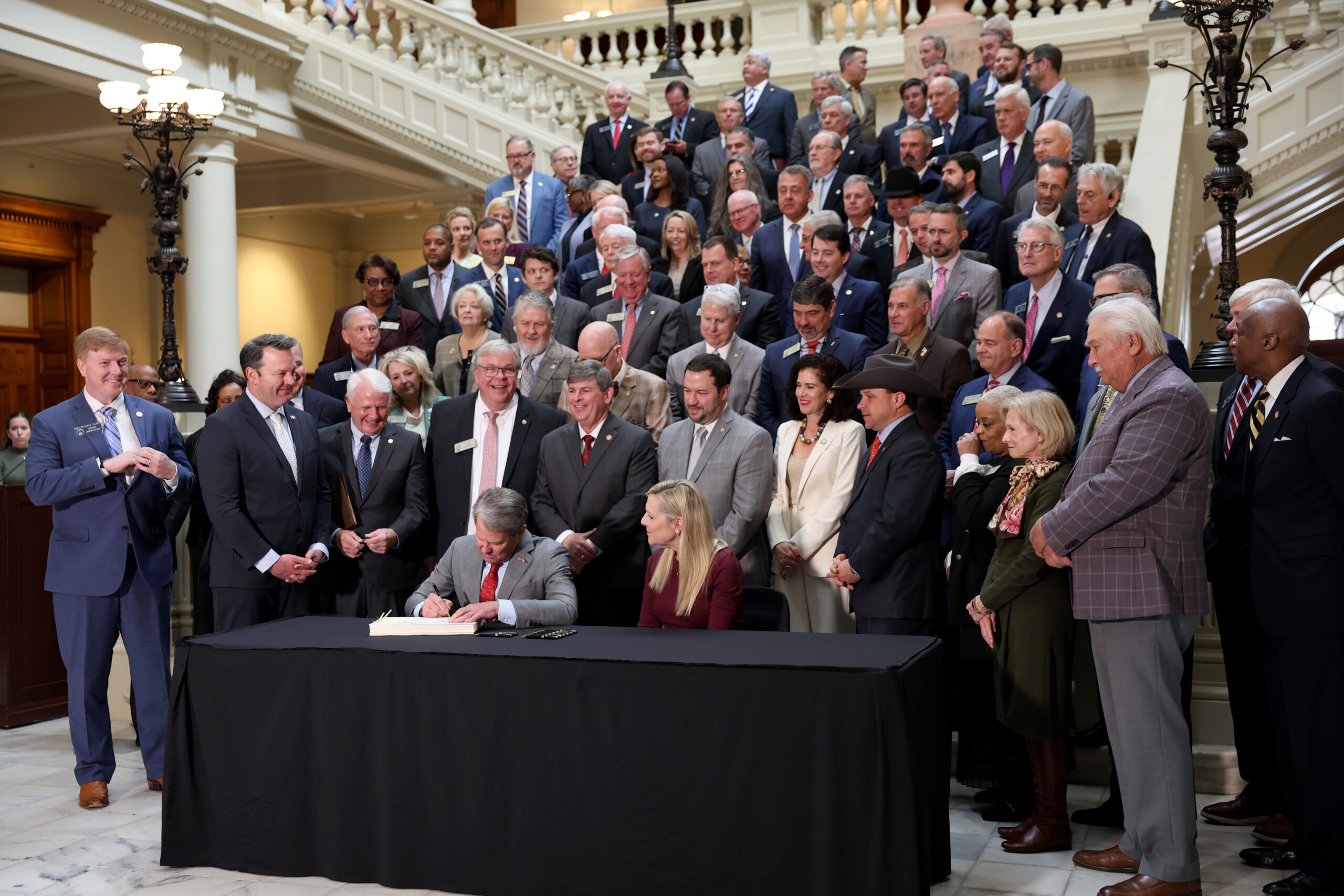 Gov. Brian Kemp signs the amended budget at the state Capitol Tuesday for the 2026 fiscal year.