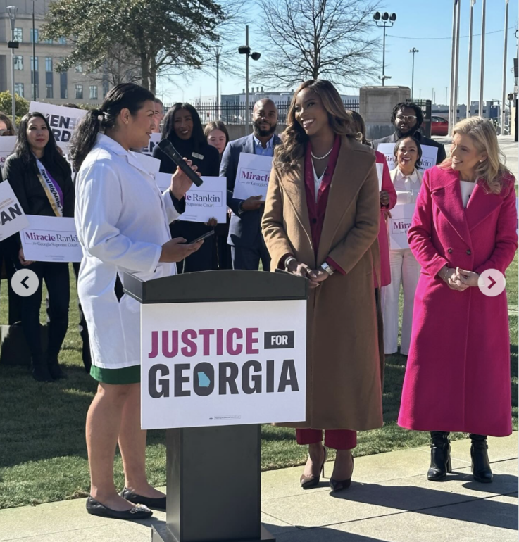 Dr. Barbara Joy Jones-Parks speaks to former state Sen. Jen Jordan and Miracle Rankin, who are both running for Georgia Supreme Court seats.
