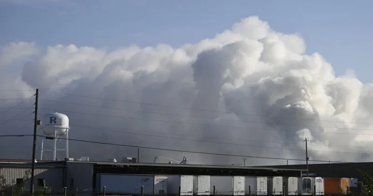 A wide photo of a large smoke plume billowing out from the fire at BioLabs in Conyers, Georgia.