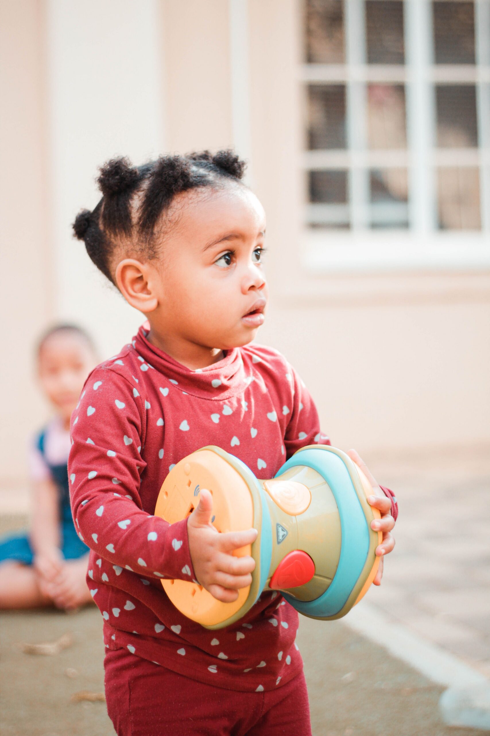 A young girl playing outside