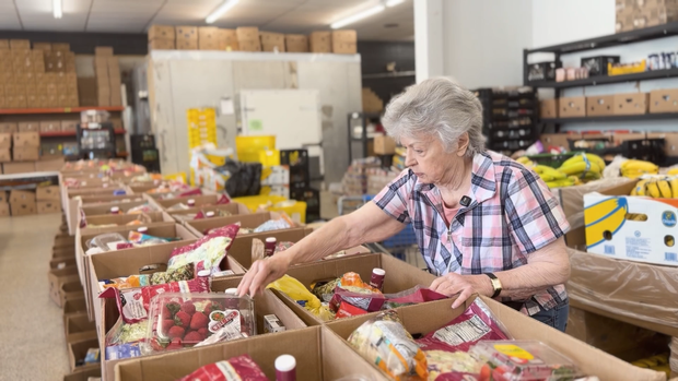 Carol Reed is one of the hundreds of volunteers who help Reflections of Trinity send meals across Georgia. She is pictured organizing food in boxes. Credit: CBS News Atlanta.