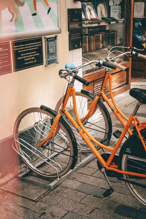 two bicycles parked outside a business