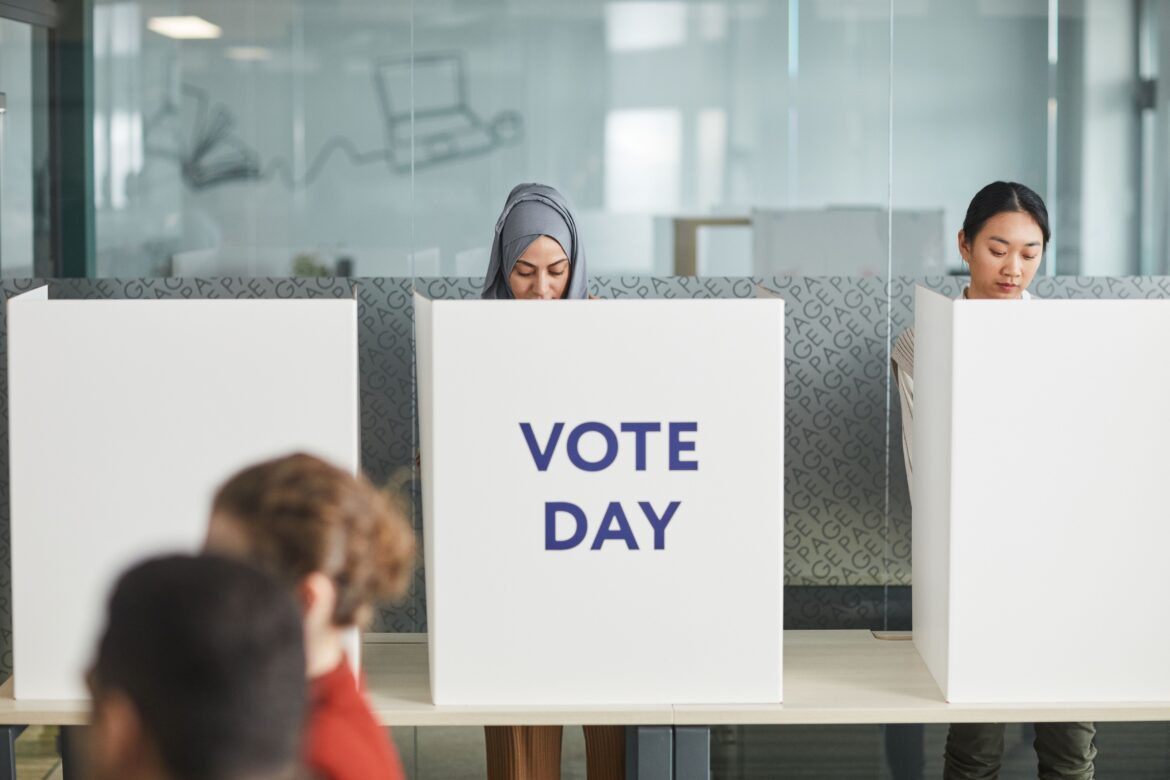 A stock photo of people at the polls.