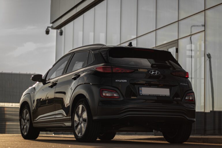 A black Hyundai SUV in front of a dealership
